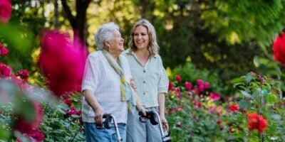 Adult,Granddaguhter,Supporting,Her,Senior,Grandmother,When,Taking,Her,For
